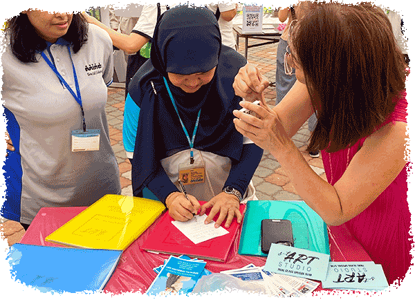 Ms Elfin guiding residents through an art activity at a neighbourhood family day