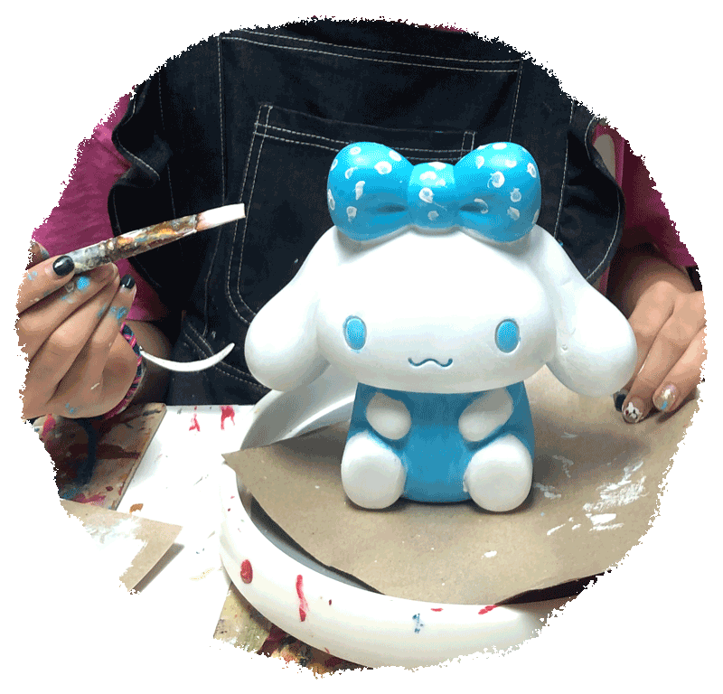 A young artist painting a Cinnamoroll figurine at stART Studio