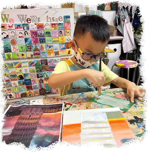 Boy painting on canvas at art studio